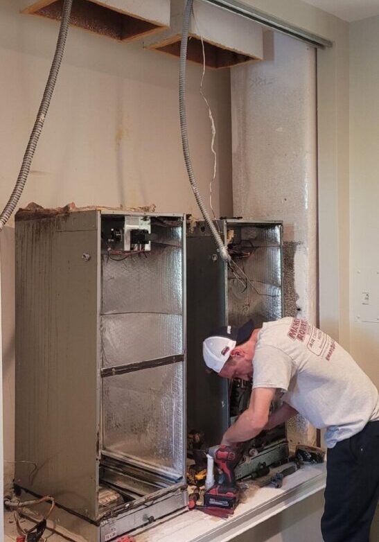 A man working on an unfinished room.